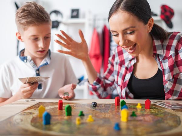 Mother and son playing board game