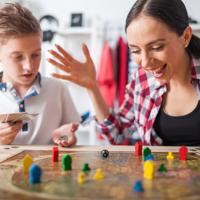 Mother and son playing board game