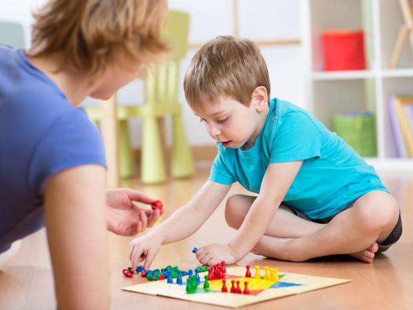 Mother and son playing board game