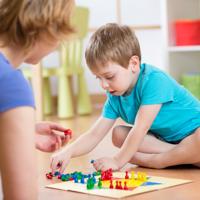 Mother and son playing board game