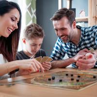 Happy family playing board game