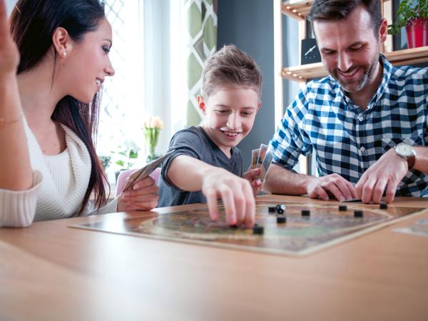 Happy family playing board games