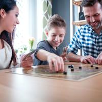 Happy family playing board games