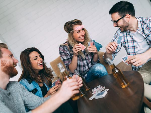 Friends playing cards and smiling