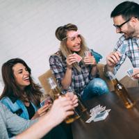 Friends playing cards and smiling